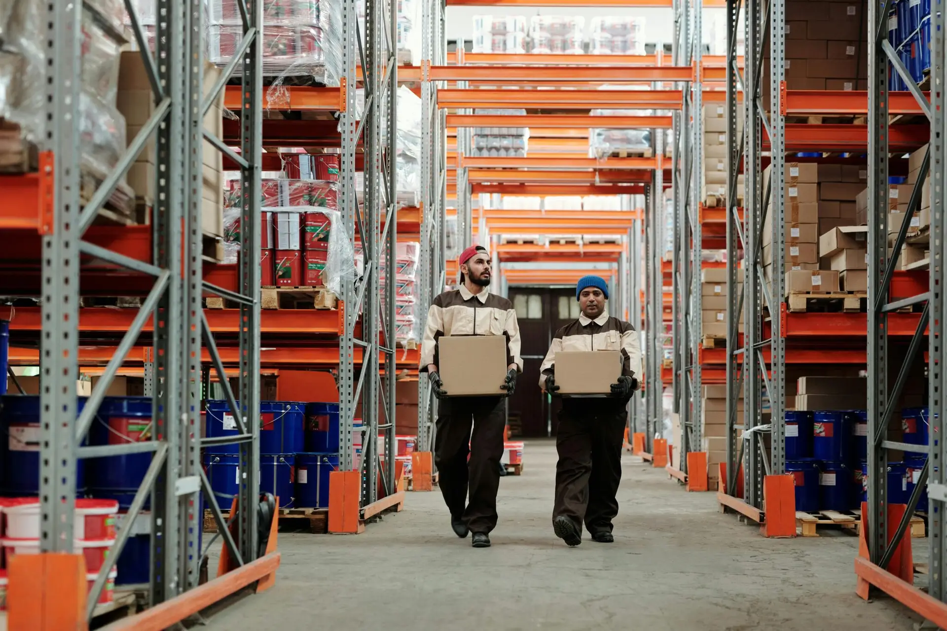 Professional movers transporting boxes in a secure warehouse storage facility